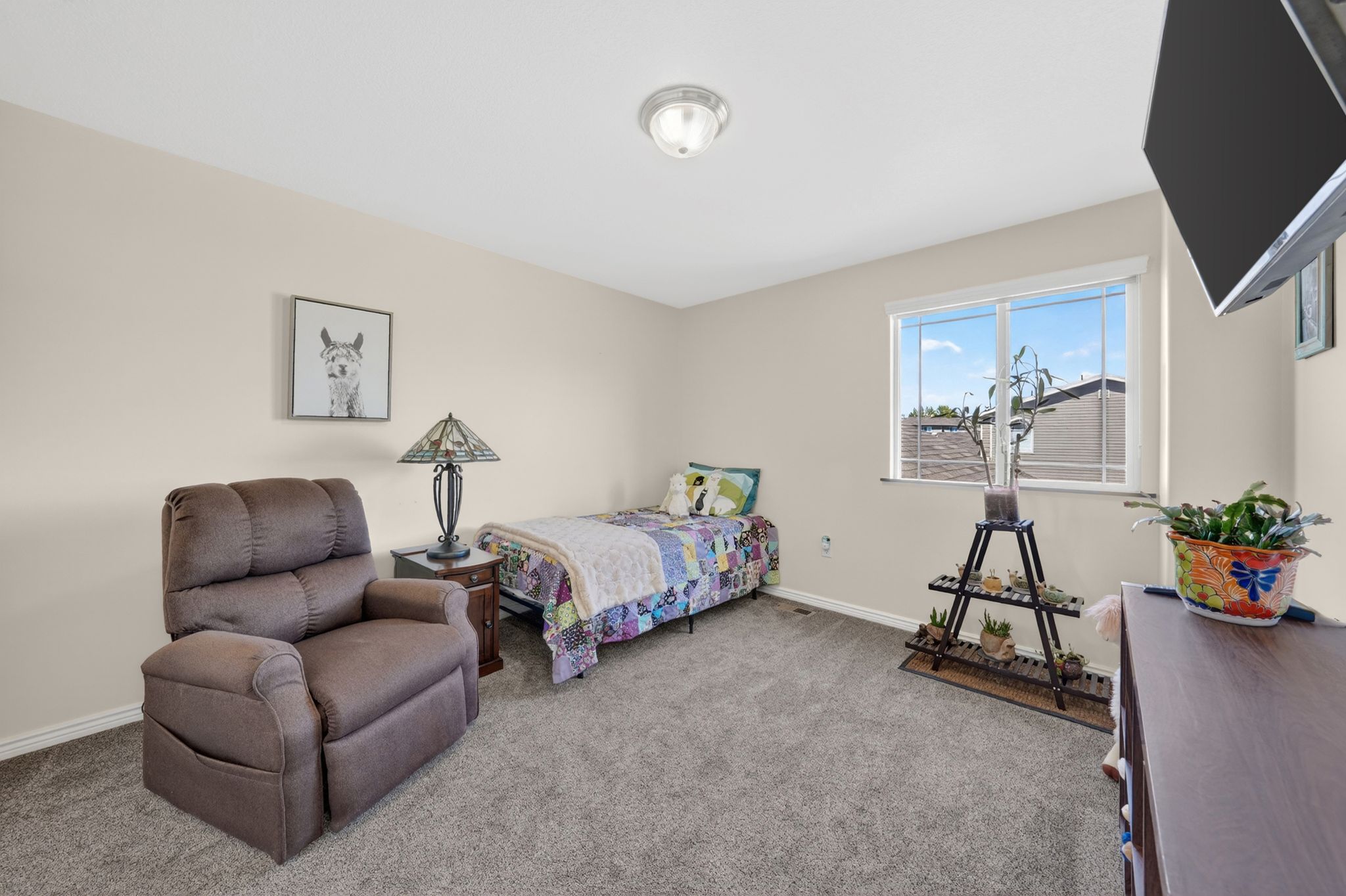 Bedroom with light colored carpet and baseboards
