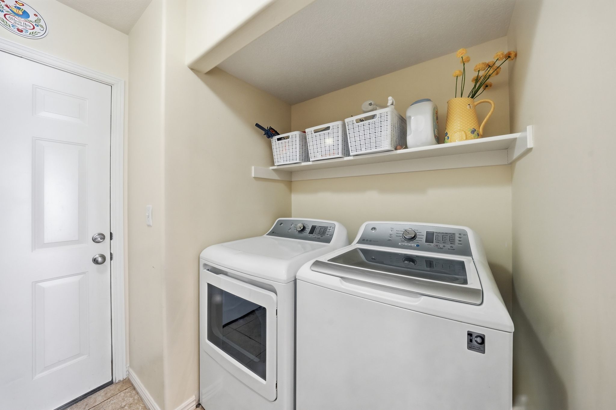 Laundry area featuring separate washer and dryer and baseboards