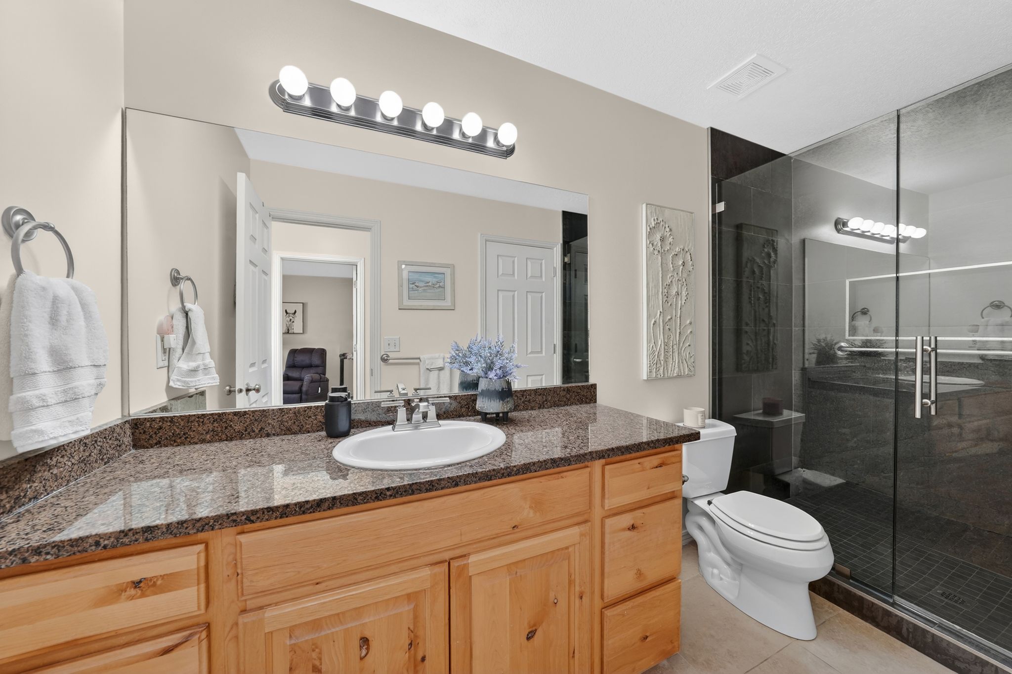 Bathroom with vanity, a stall shower, and light tile patterned flooring
