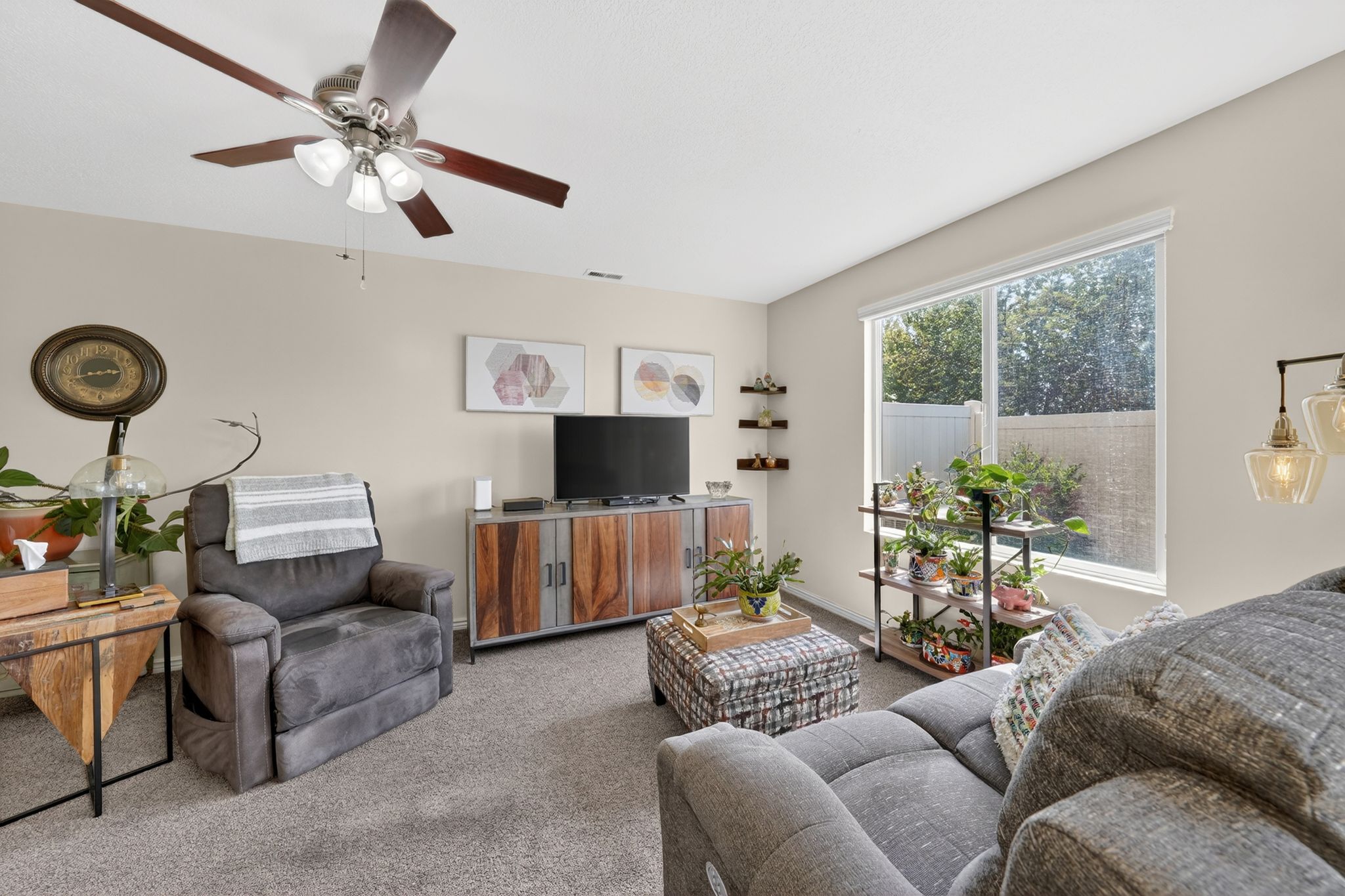 Carpeted living room with ceiling fan