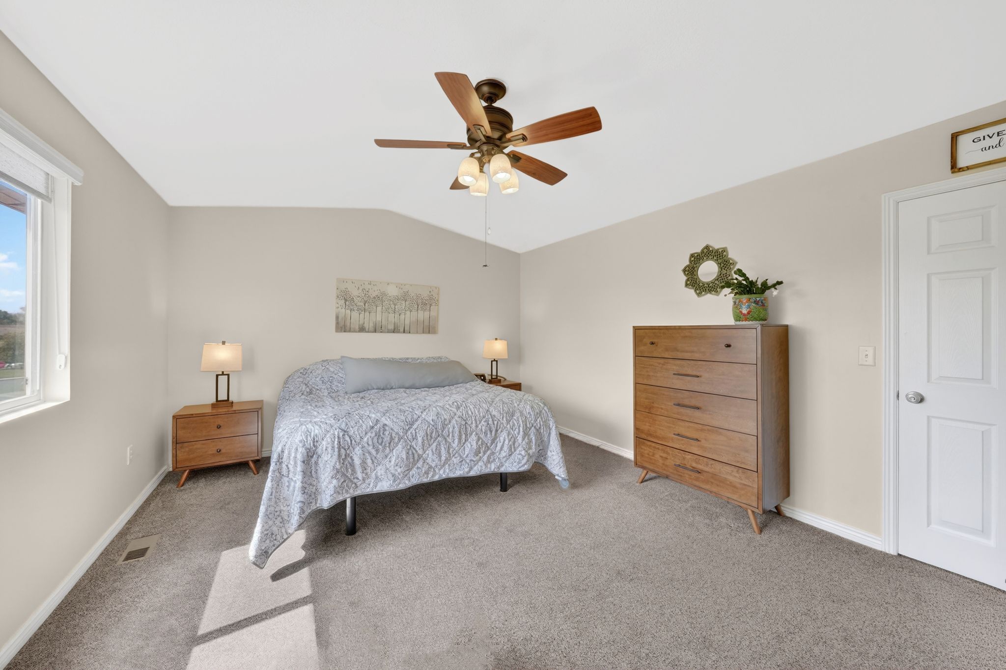 Bedroom with carpet flooring, lofted ceiling, and a ceiling fan