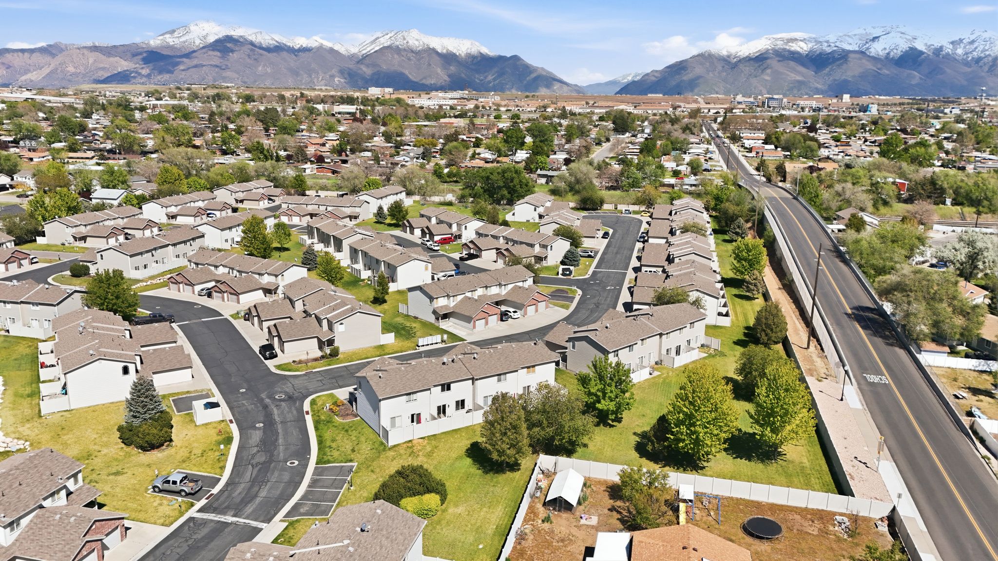 View of property location with mountains and nearby suburban area