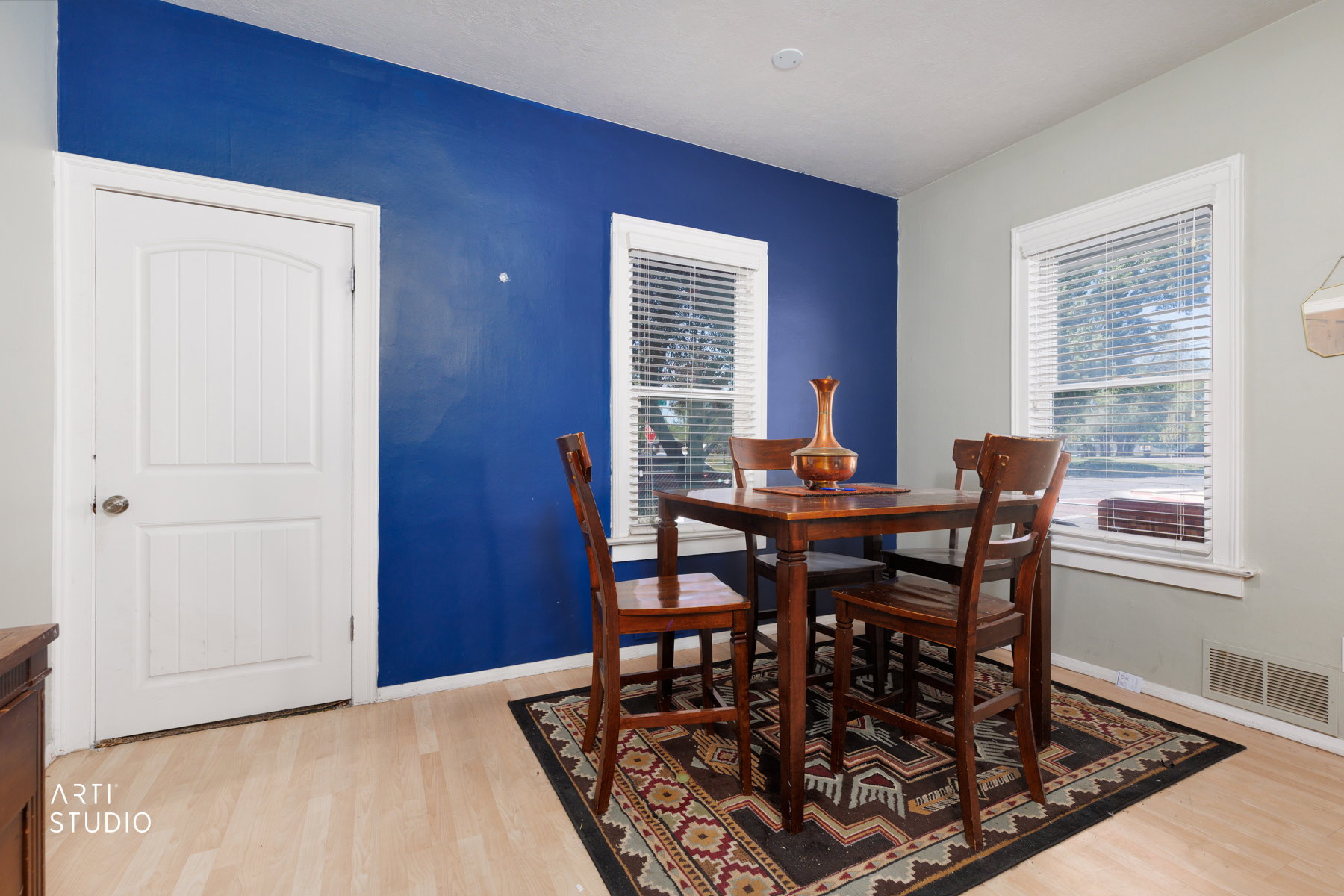 Interior room featuring light wood-finish flooring and a distinctive accent wall