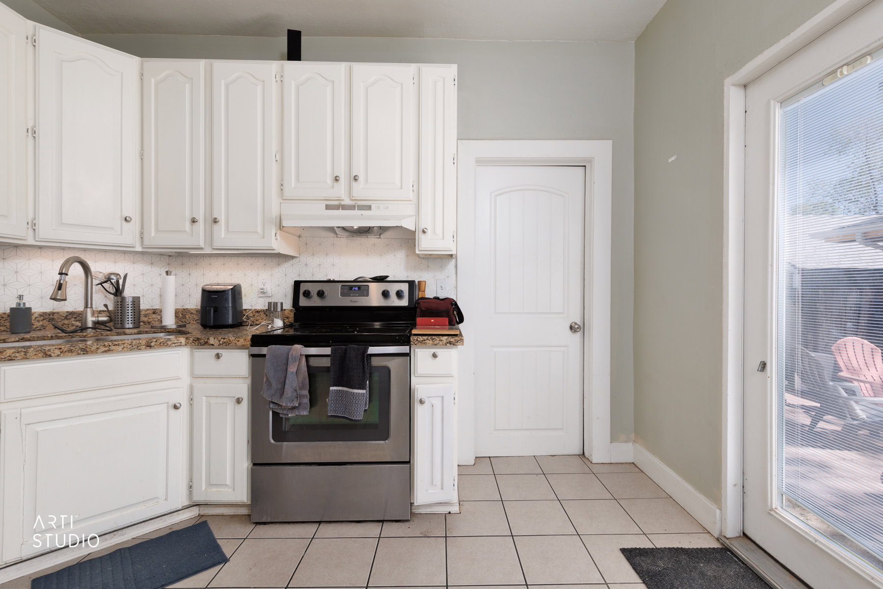 Kitchen featuring white cabinetry, a stainless steel range, and a stainless steel sink with a gooseneck faucet