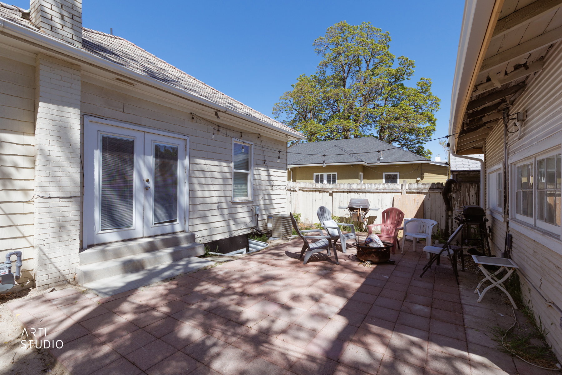 Brick paver patio with perimeter fencing, back patio