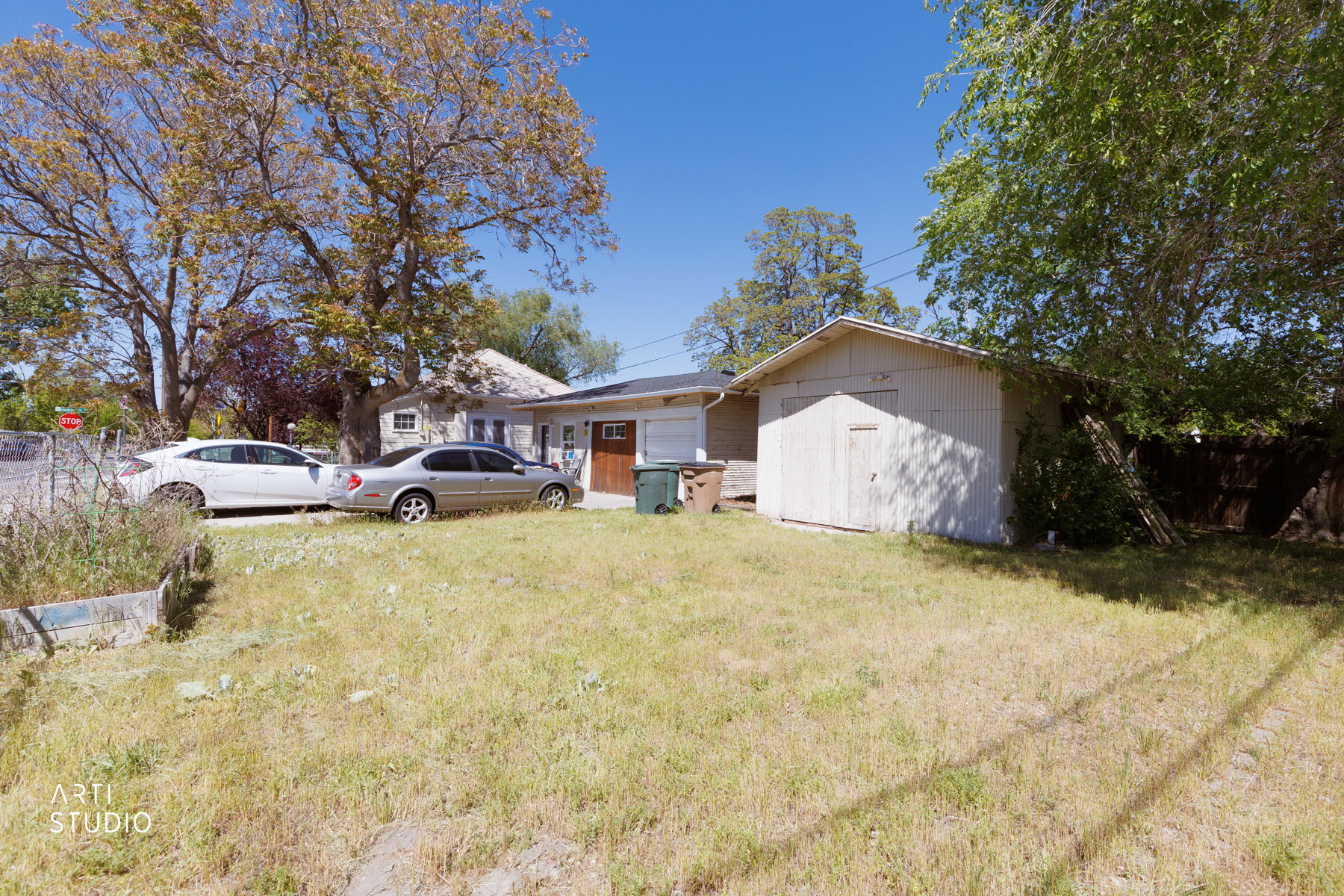 backyard beyond driveway and workshop