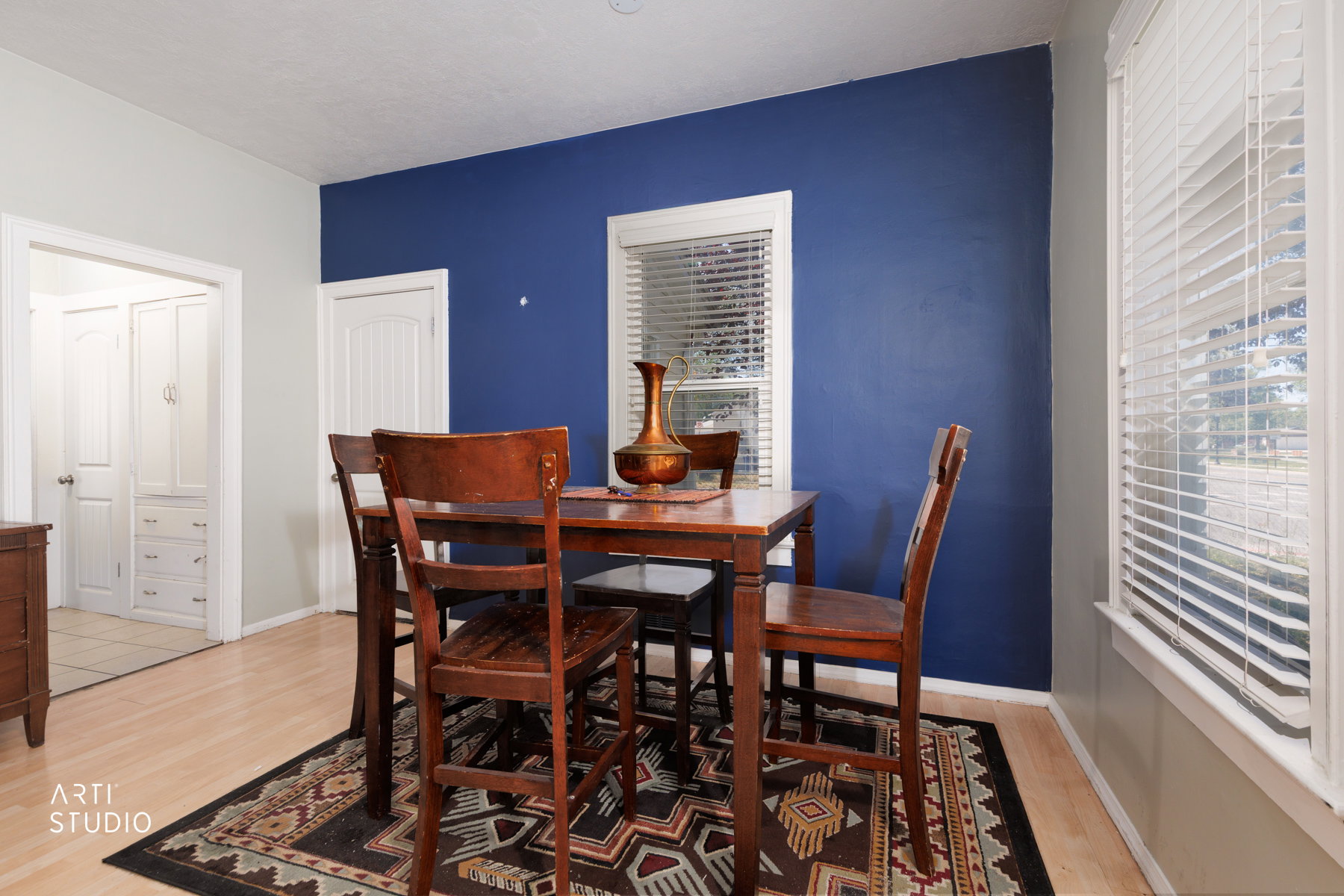 Light wood-finish flooring with a contrasting accent wall