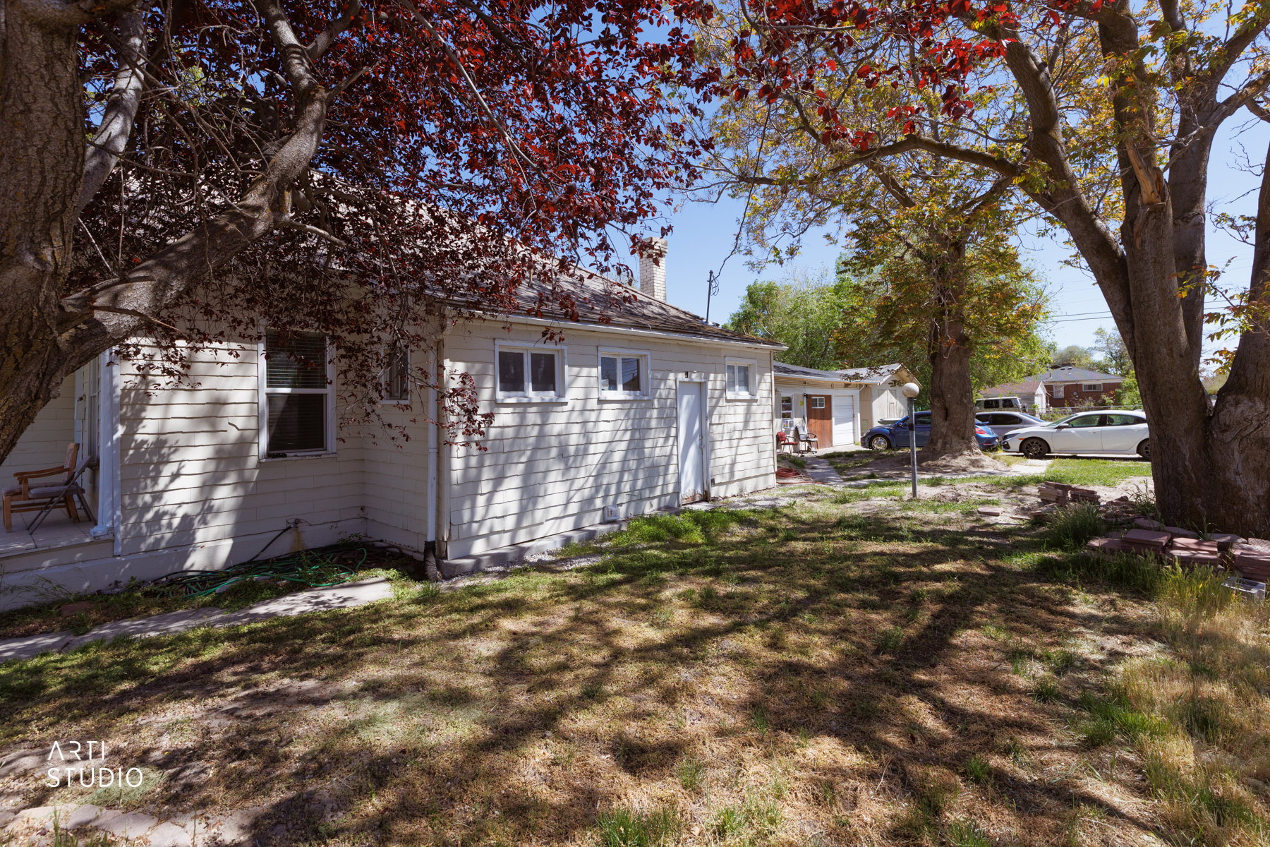 Exterior siding with multiple windows and a side entry door west facing side