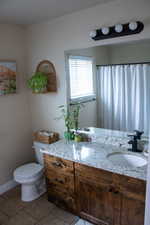 Dual-sink vanity with a granite countertop, undermount sinks, and rustic wood-finish cabinetry