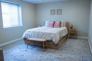 Neutral tone walls complement the light-colored carpet flooring