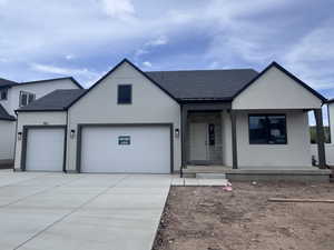 Modern stucco exterior featuring stone accents and a covered entry