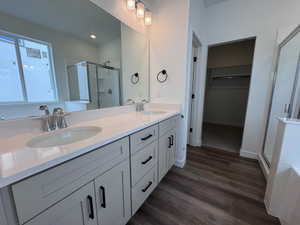 Dual vanity with light-toned cabinetry and black hardware