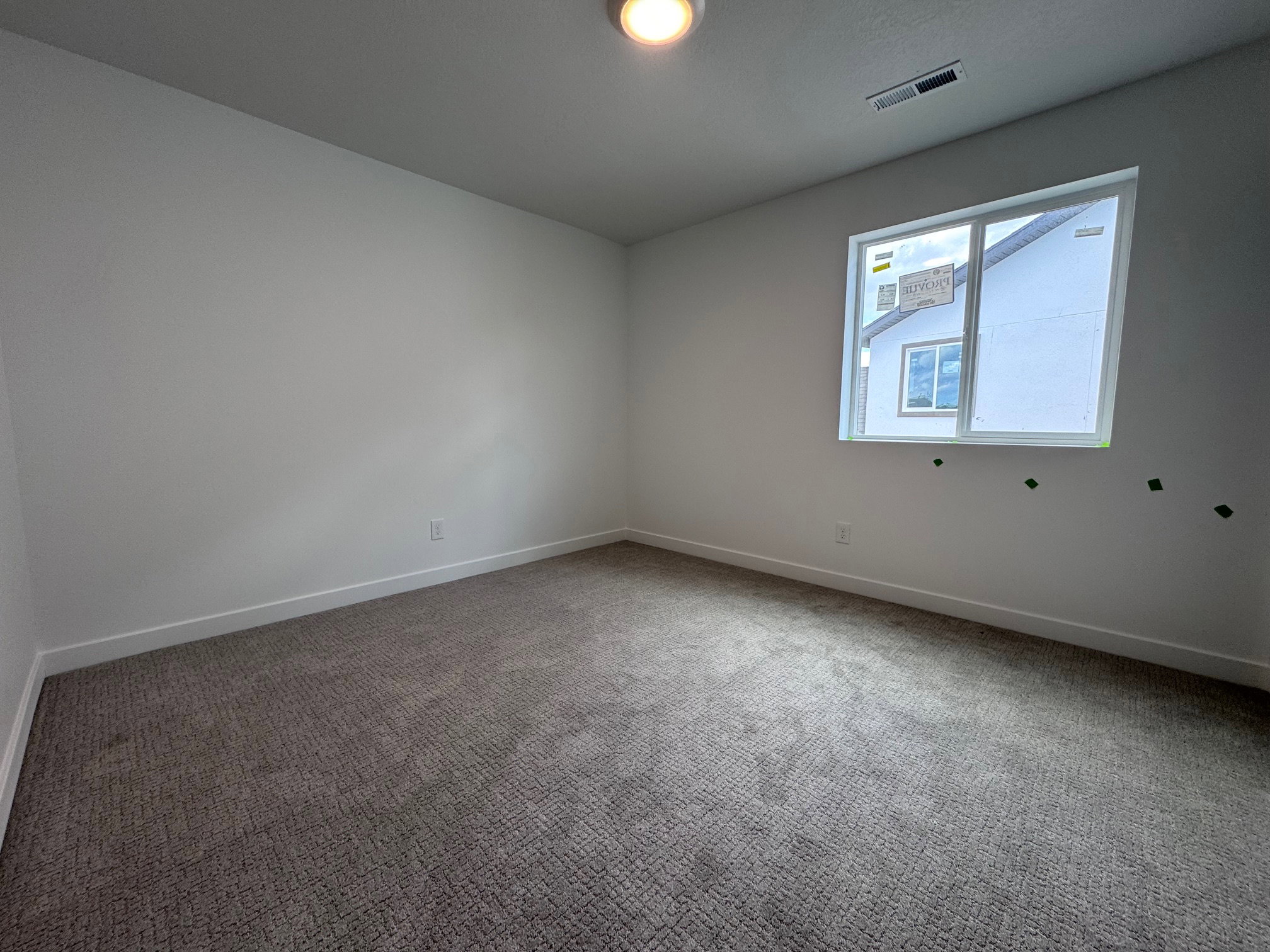 Carpeted room with a recessed window featuring white trim