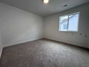 Carpeted room with a recessed window featuring white trim