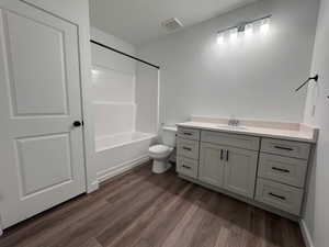 Bathroom featuring a single vanity with light-colored countertop, undermount sink, and matte black hardware
