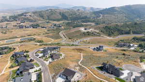 Expansive hillside community featuring multiple modern residences and extensive natural landscaping