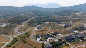 Expansive aerial showcasing a mountainous landscape with developed residential areas