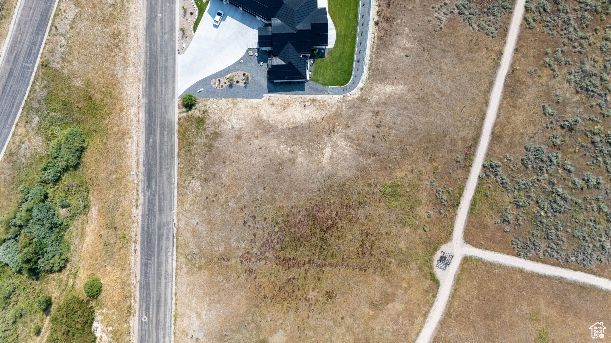 Expansive land parcel featuring open terrain and adjacent roadways