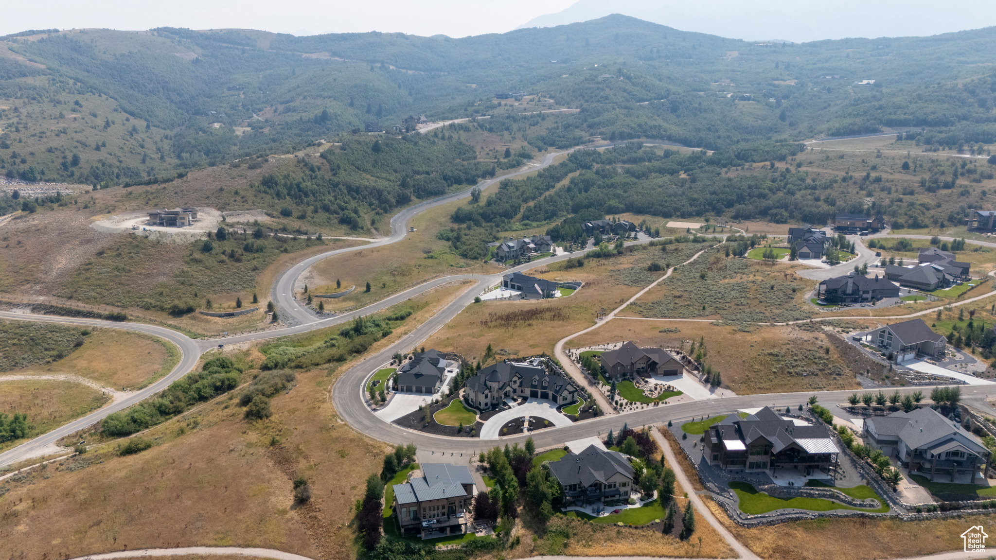 Aerial perspective showcasing a residential development carved into a mountainous landscape
