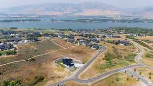 Aerial perspective showcasing residential development with a prominent lake and distant mountains