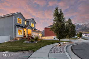 Two-story residence featuring light gray siding and a stone accent facade