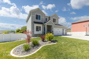 Two-story residence featuring light gray siding, white trim, and a covered front entry