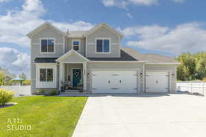 Light gray siding exterior with a dark teal entry door
