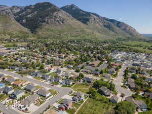 Residential neighborhood featuring a diverse collection of single-family homes, mature trees, and paved streets