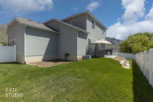 Exterior featuring a stucco finish, a private patio, and a tiered grassy area