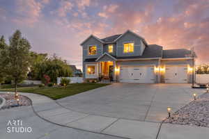 Two-story residence featuring light gray siding and a dark shingle roof