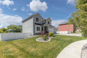 Two-story residence featuring light gray siding with white trim, a black shingle roof, and an attached two-car garage