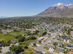 Expansive community with varied architectural styles, established residential areas, and mountain backdrop