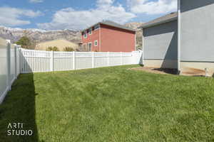 Manicured lawn with a white privacy fence