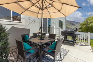 Expansive concrete patio featuring a privacy fence, string lighting, and direct access to interior via sliding glass door