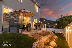 Patio with privacy screen, string lighting, and direct access to the interior