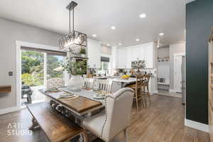Open concept kitchen and dining area featuring wood-finish flooring