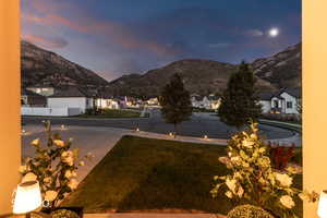 Paved driveway with integrated pathway lighting and a manicured lawn area