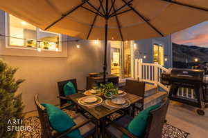 Outdoor patio with string lighting and a neutral-toned umbrella