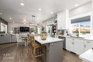 Kitchen island with a white countertop and seating for three