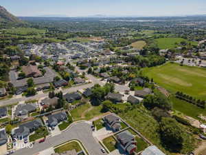 Residential neighborhood featuring established homes, mature trees, and a mountain backdrop