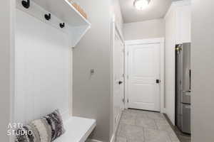 Built-in mudroom bench with paneled backing and integrated coat hooks