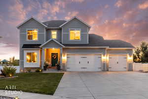 Contemporary two-story residence featuring light gray siding and a dark shingle roof