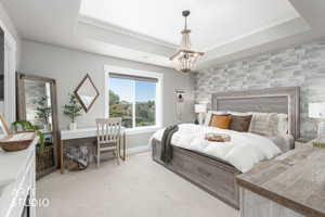 Bedroom featuring a tray ceiling, recessed lighting, and a chandelier
