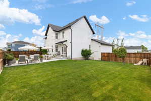 Expansive green lawn with a private fenced perimeter