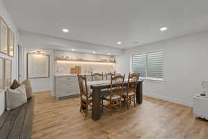 Spacious room featuring wood-finish flooring and recessed lighting