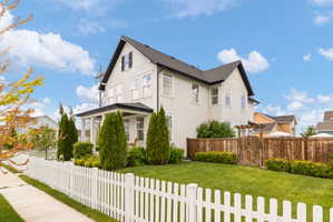 White picket fence framing a manicured lawn