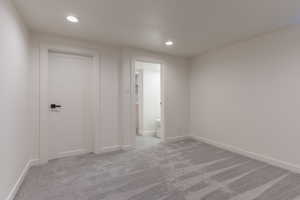 Carpeted room featuring recessed lighting, white walls, and white trim