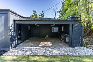 Covered outdoor area featuring a stone slab floor, built-in counter space, and a window