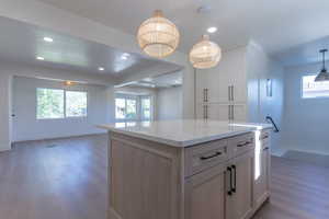 Kitchen island with a light-toned countertop and wood-finish cabinetry