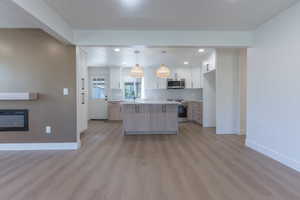 Open-concept living space featuring wood-finish flooring